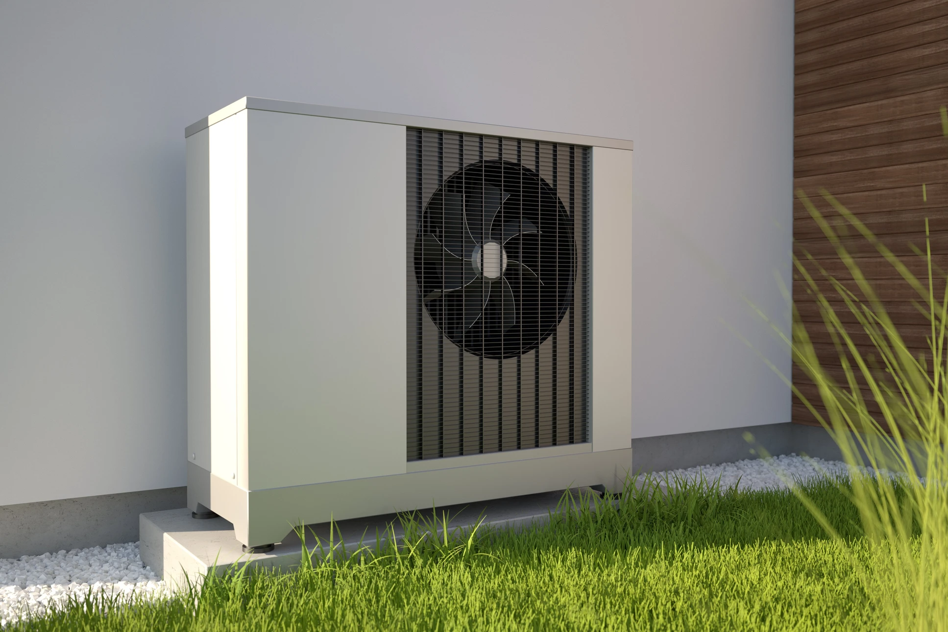 Deux pompes &agrave; chaleur air-eau install&eacute;es &agrave; l'ext&eacute;rieur d'une maison moderne avec bardage bois vertical